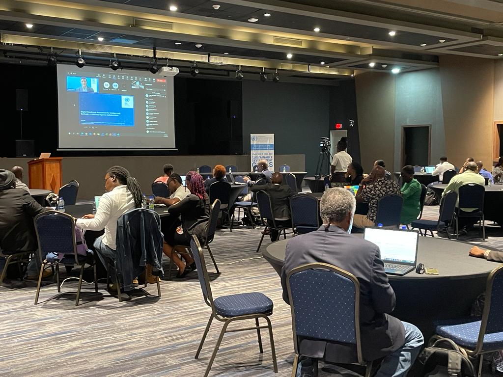 Participants at the UN Digital Readiness Assessment Workshop. Participants are using laptops and dressed in business attire.