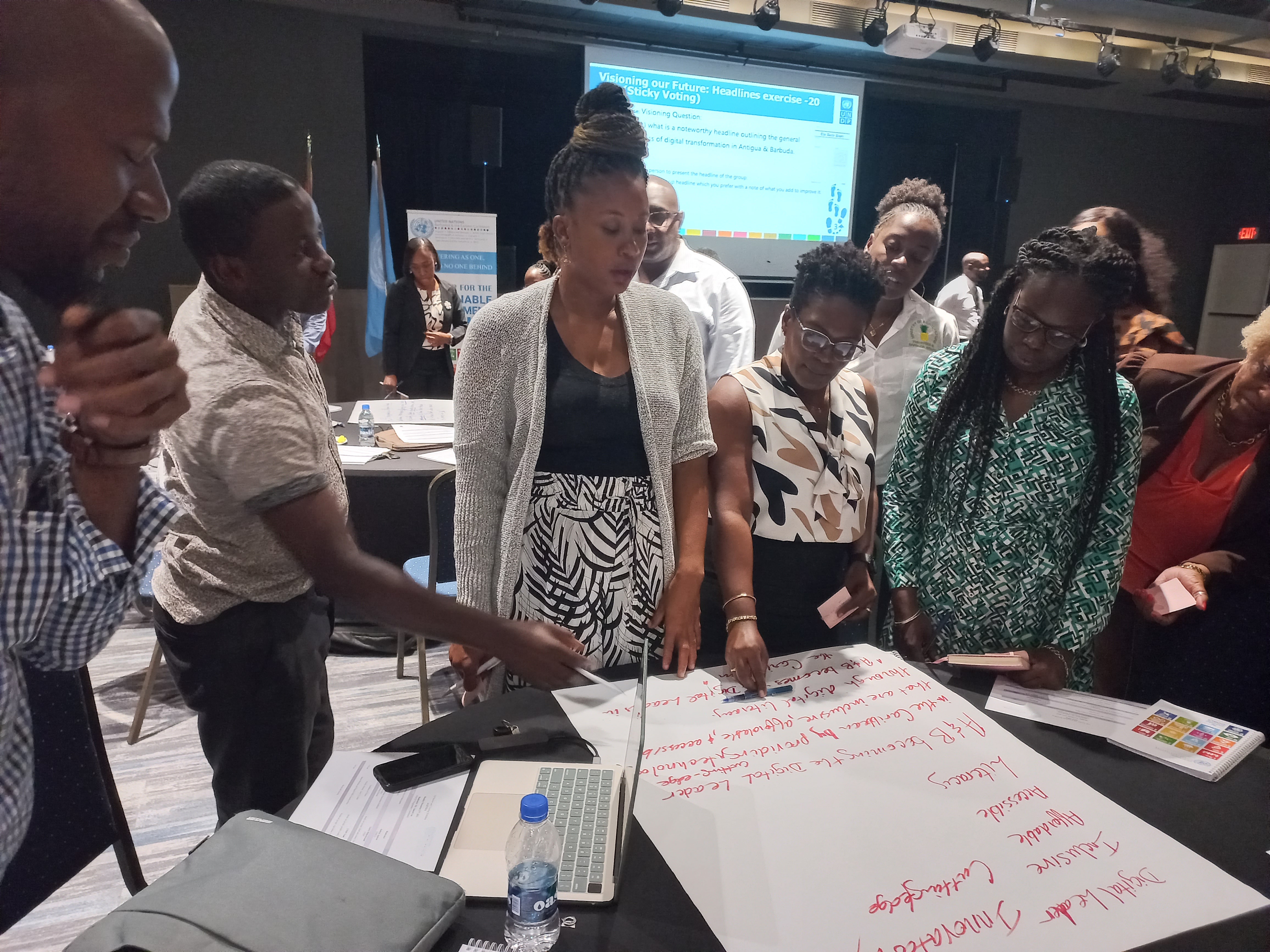 Andell Trotman - Field Coordinator, Department of Social Policy, Research and Planning within Ministry of Social Transformation, (second left), Mellissa Johnson- Head of Office for UNDP in Antigua and Barbuda, Dr. Gemma Chery - Country Specialist for Antigua and Barbuda for PAHO/WHO and Natalia Lawrence - National Coordinator of the GEF Small Grants Programme review the vision statements made by stakeholder groups.
