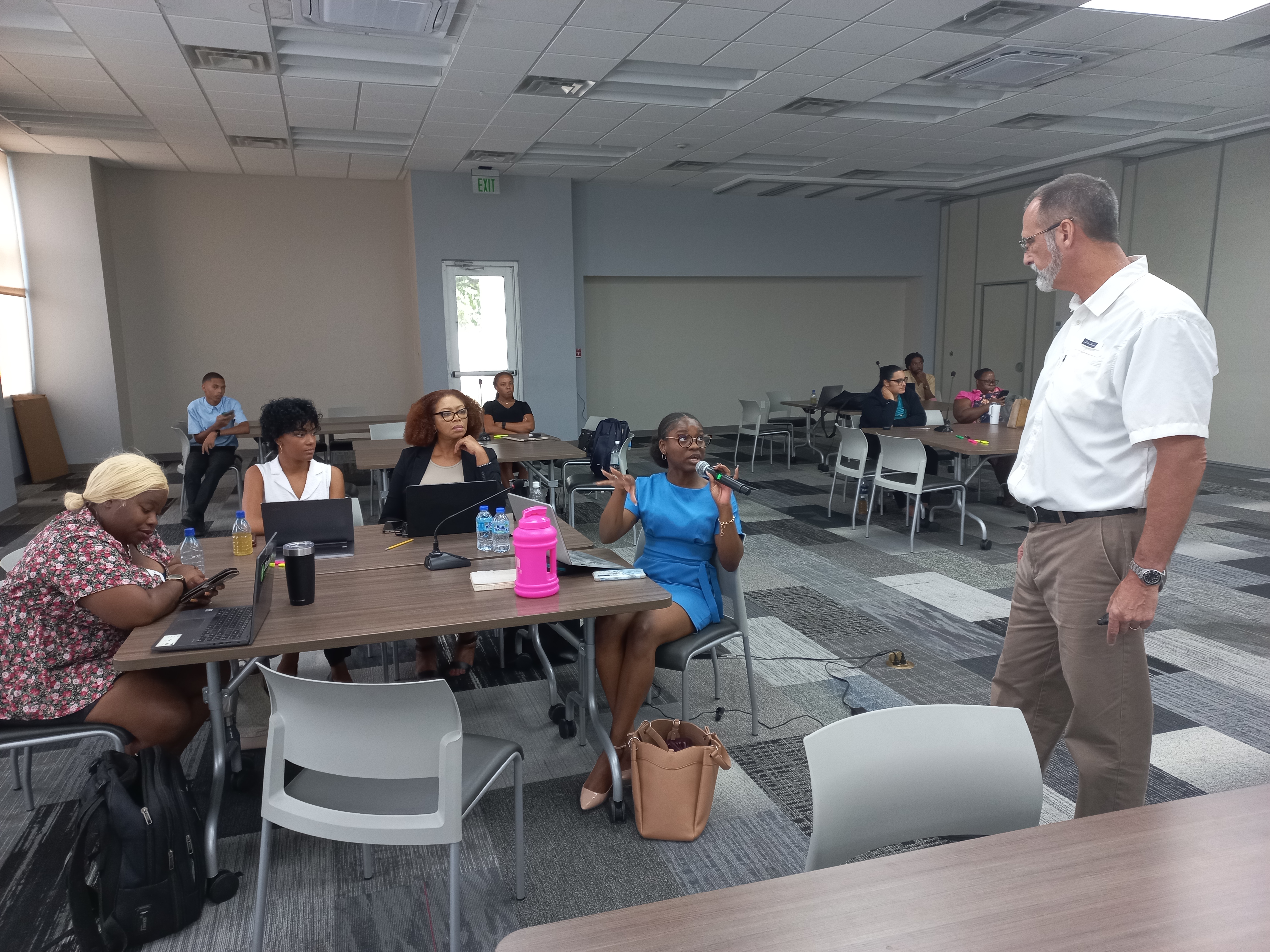 Dennis Adam, Co-founder of Antigua Recon, engages Attorney Desrie Markham, during his presentation on cybersecurity awareness.